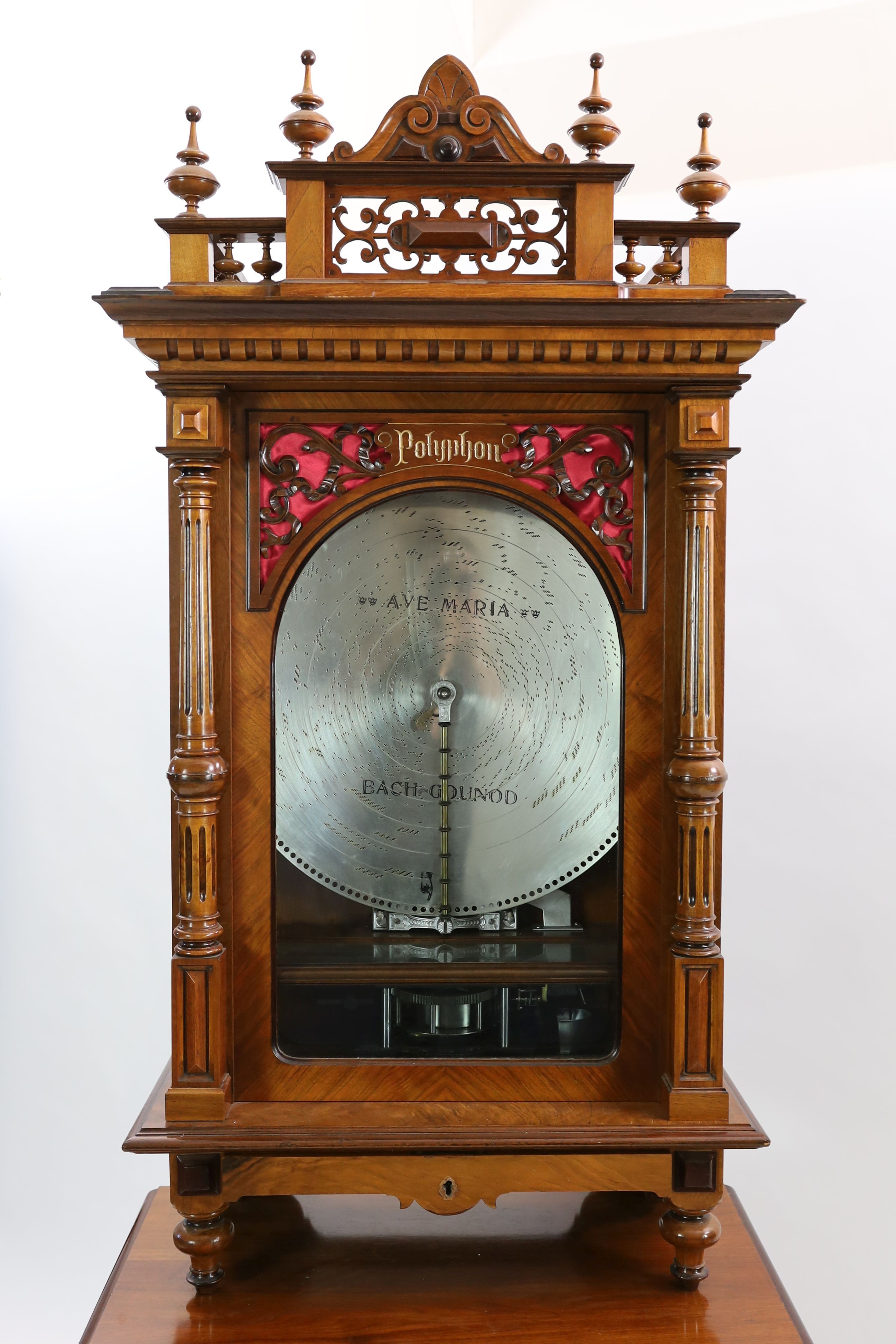 A 19th century oak and walnut cased coin operated Polyphon disc music player retailed by Nicole Freres Leipzig, the double vertical steel comb playing 24.5 inch discs, the carved column floor standing case with pierced p
